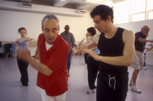 Martin Thall, a member of the Brooklyn Parkinson, dances with David Leventhal of the Mark Morris Dance Group. Photo by Katsuyoshi Tanaka.