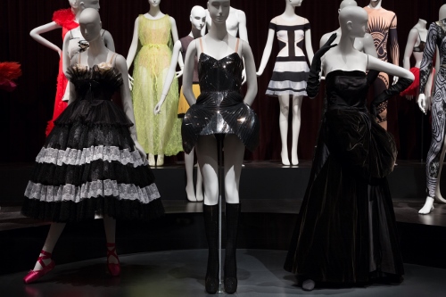 Installation view of Dance & Fashion, featuring (L to R), costume designs by Valentino Garavani, Iris van Herpen, and 'Cygne Noir' haute couture gown by Christian Dior. Photograph © The Museum at FIT, New York.