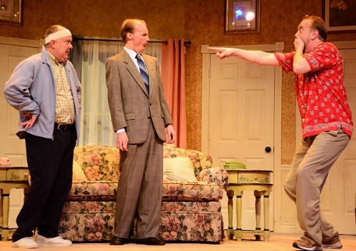 Stanley Gardner (Jeff Stockberger), right, is shocked as he realizes that his friend and neighbor John Smith (Eddie Curry), left, is implying to police Sergeant Troughton (A.J. Morrison), center, that the two men are in a relationship as a last-ditch effort to cover up Smith’s double life in Beef & Boards Dinner Theatre’s production of 'Run for Your Wife.'