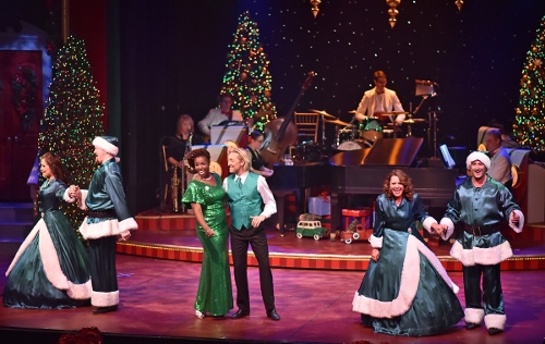 Backed by the Beef & Boards Orchestra, Renée Jackson and Kenny Shepard (center) join the Beef & Boards Quartet (from left) Marisa Rivera, Peter Scharbrough, Betsy Norton and Kyle Durbin in a rousing rendition of “Rocking Around The Christmas Tree” in the 25th Annual A Beef & Boards Christmas, now on stage at Beef & Boards Dinner Theatre.