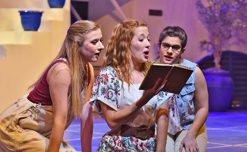Sophie (Rachelle Rose Clark), center, reads the revealing stories in her mother’s diary to her bridesmaids Lisa (Lauren Morgan), left, and Ali (Chloe Kounadis) in Beef & Boards Dinner Theatre’s production of Mamma Mia! Now on stage, the Broadway mega-hit musical features the songs of the Swedish super group, ABBA, tells the story of a bride’s search for her birth father on a Greek island paradise.