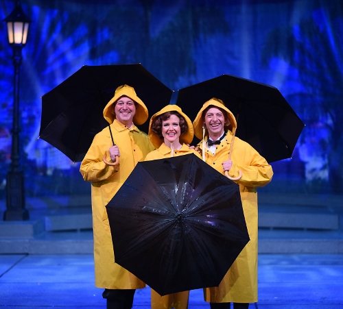 Trio with umbrellas: From left: Don Lockwood (Timothy Ford), Kathy Selden (Kimberly Doreen Burns), and Cosmo Brown (Buddy Reeder) are ready for Beef & Boards Dinner Theatre’s production of 'Singin’ in the Rain,' now on stage through May 26.