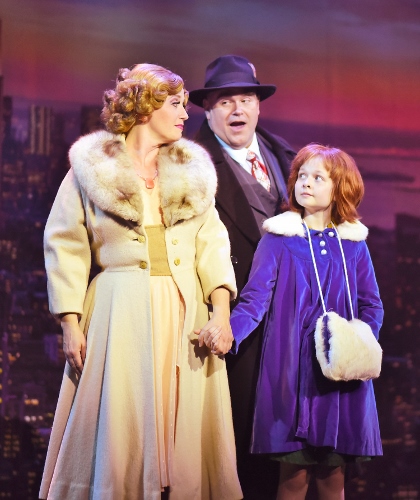 NYC: Oliver Warbucks (Ty Stover), center, sings about “NYC” to Grace (Bobbi Bates), left, and Annie (Claire Kauffman), right, during the child’s first night out on the town in Beef & Boards Dinner Theatre’s production of Annie, now on stage through July 15.