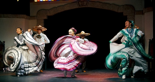 Guest artists at a performance include a Mexican folkloric troupe.