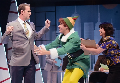 Overwhelmed with excitement at their first meeting, Buddy (Dan Bob Higgins), center, rushes to hug his father Walter Hobbs (Mark Epperson) but is pulled back by Deb (Lanene Charters) in Beef & Boards Dinner Theatre’s production of Elf, The Musical, now on stage through Dec. 31.