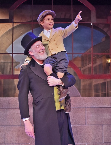 After finding redemption on Christmas Day, Ebenezer Scrooge (Jeff Stockberger) enjoys some time with Tiny Tim (Ashton Curry) in Beef & Boards Dinner Theatre’s production of A Christmas Carol, on stage select dates through Dec. 21.