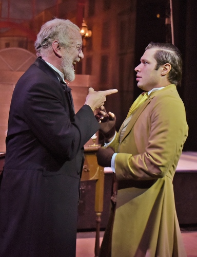 Bob Cratchit (Logan Moore), right, is stunned at the sudden transformation of his employer, Ebenezer Scrooge (Jeff Stockberger), left, in Beef & Boards Dinner Theatre’s production of A Christmas Carol, on stage select dates through Dec. 21.