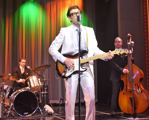 Buddy Holly (Kyle Jurassic) performs with the Crickets, Jerry Allison (Josh McLemore), on drums, and Joe Maudlin (James Daley), on bass, in Beef & Boards Dinner Theatre’s production of Buddy: The Buddy Holly Story, now on stage. This high-energy musical features Buddy’s greatest hits including “Oh Boy,” “Peggy Sue,” and “Everyday.”