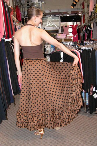 Cecilia is wearing a Halter Leotard from the Premiere Collection by Body Wrappers, Style P802, $48.99; Light Brown Flamenco Skirt, $69.99; and Gold 'Karen' shoes from Freed of London, $119. Available at <a href='http://www.onstagedancewear.com'>OnStageDancewear.com</a>.
