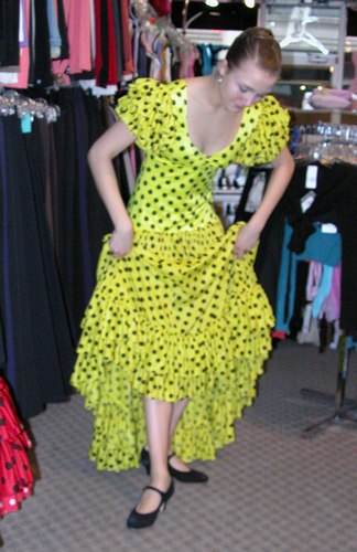 Cecilia is wearing a Yellow Sevillana Flamenco Dress, Style DW899Y, by Star Styled Joanna Designs, $169.95; and Black Ball*Pilmar Flamenco Shoes, Style 523, Distributed by Freed of London, $129.95. Available at <a href='http://www.onstagedancewear.com'>OnStageDancewear.com</a>.