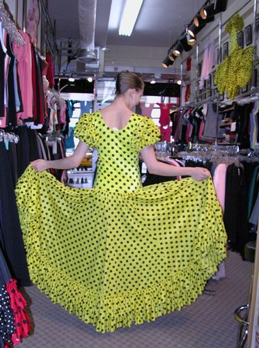 Cecilia is wearing a Yellow Sevillana Flamenco Dress, Style DW899Y, by Star Styled Joanna Designs, $169.95; and Black Ball*Pilmar Flamenco Shoes, Style 523, Distributed by Freed of London, $129.95. Available at <a href='http://www.onstagedancewear.com'>OnStageDancewear.com</a>.