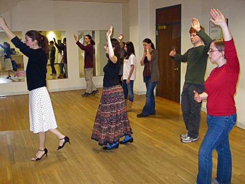 Arthur Murray teacher Christine McCarthy leads a group of high school students in Boston in ballroom dance moves. The students signed onto the class as their athletic requirement for the semester.
