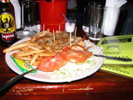 Still life with fajitas and fries, beer and menu