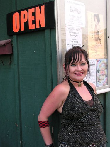 Employee Tammy Rose, on the Players Pub wait staff, beside the OPEN sign