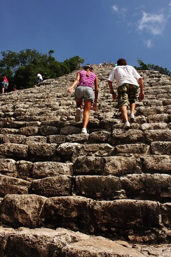 Visitors head to the top of an ancient Mayan pyramid